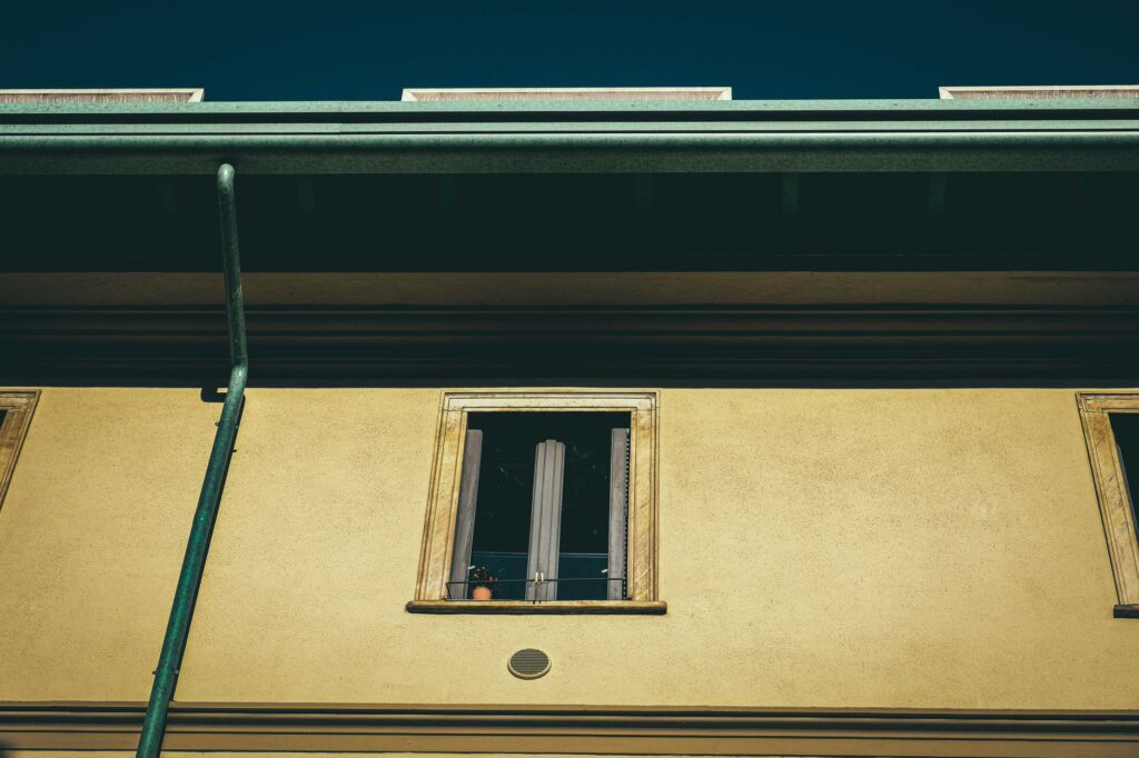 Complete Gutter Cleaning Near Me in Ocala Guide for 2026 Homeowners 1 professional performing gutter cleaning on a two-story Ocala home