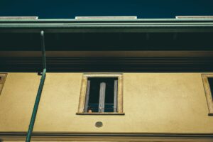 Professional performing gutter cleaning near me on a two-story in Ocala home.