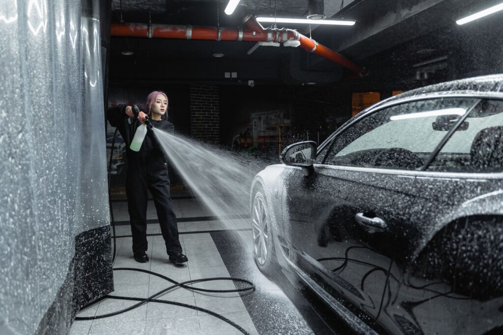 The Ocala Roof Cleaning Guide: Safe Algae Removal for 2026 2 technician performing low pressure soft wash on asphalt shingles near Gainesville FL