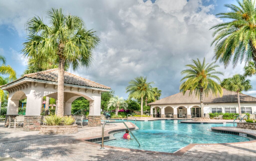 Paver Sealing in Lake Panasoffkee: Protect Your Pavers for Good 2 technician applying paver sealer to a Lake Panasoffkee pool deck
