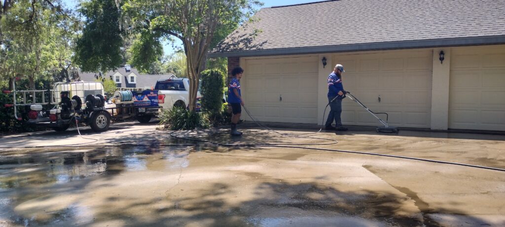 How Ocala Homeowners Choose Concrete Power Washing and Sealing Companies Near Me in 2026 1 technician performing concrete power washing and sealing companies near me service on Ocala driveway